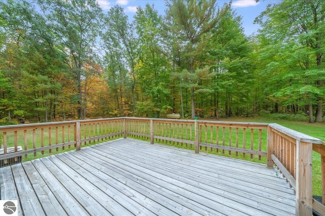 wooden terrace with a lawn