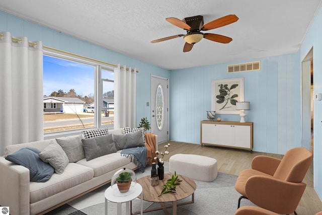 2280 NW Tamara Rd, Kalkaska, MI 49646 - living room featuring ceiling fan, visible vents, and wood finished floors