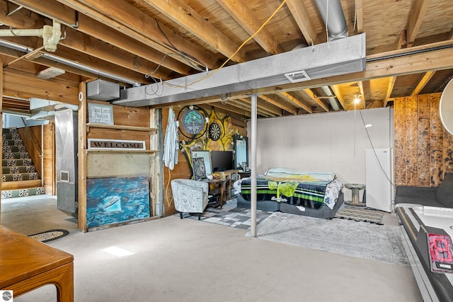 2280 NW Tamara Rd, Kalkaska, MI 49646 - unfinished below grade area with freestanding refrigerator and visible vents