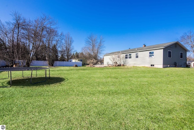 2280 NW Tamara Rd, Kalkaska, MI 49646 - view of yard featuring a trampoline and fence