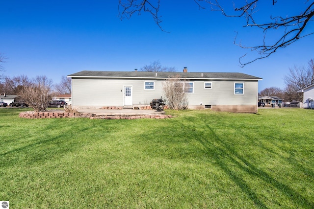 2280 NW Tamara Rd, Kalkaska, MI 49646 - rear view of property featuring a patio, a chimney, and a yard