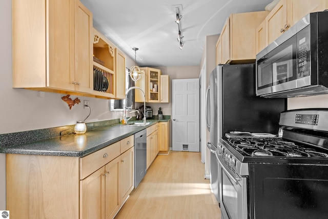 2280 NW Tamara Rd, Kalkaska, MI 49646 - kitchen with light brown cabinetry and stainless steel appliances