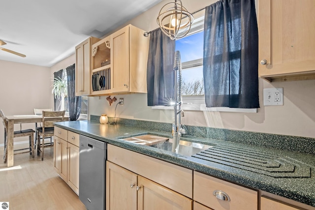 2280 NW Tamara Rd, Kalkaska, MI 49646 - kitchen with a ceiling fan, dark countertops, light brown cabinetry, stainless steel dishwasher, and light wood-style flooring