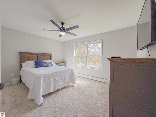 bedroom with light colored carpet, a ceiling fan, baseboards, and baseboard heating