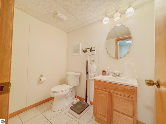 bathroom featuring tile patterned flooring, vanity, toilet, baseboards, and visible vents