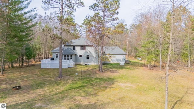 view of yard with a view of trees and a wooden deck
