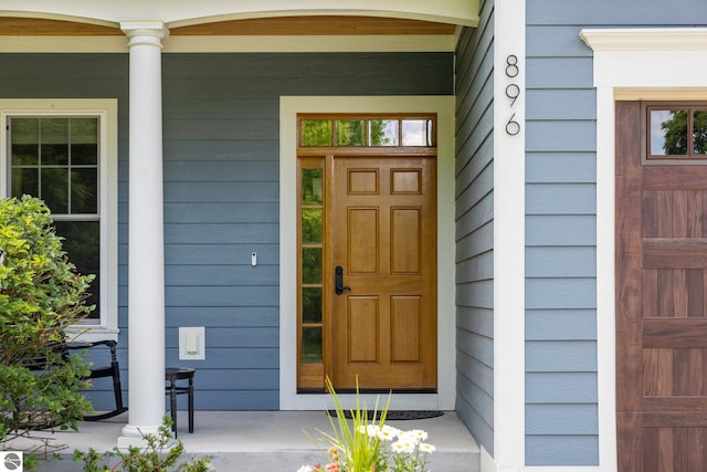 view of exterior entry with covered porch