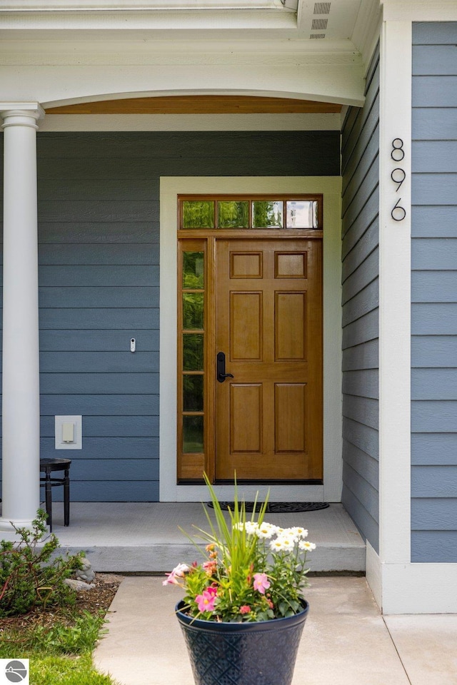 doorway to property featuring visible vents and covered porch