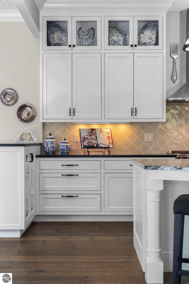 bar with crown molding, decorative backsplash, ventilation hood, and dark wood-type flooring