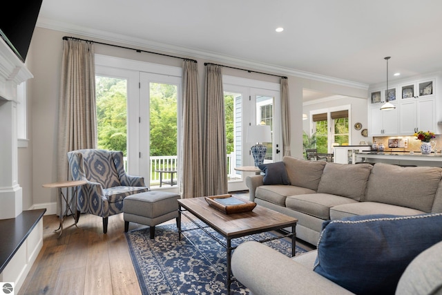 living room featuring crown molding, recessed lighting, and dark wood finished floors