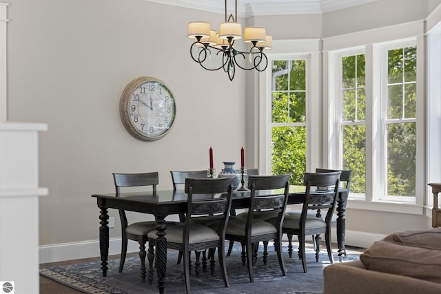 dining space featuring crown molding, baseboards, and plenty of natural light