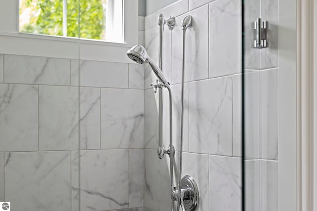interior details featuring a tile shower