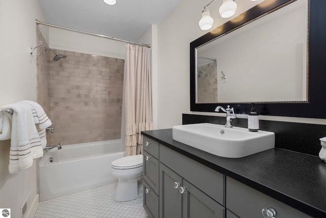 bathroom featuring vanity, tile patterned floors, toilet, and shower / tub combo