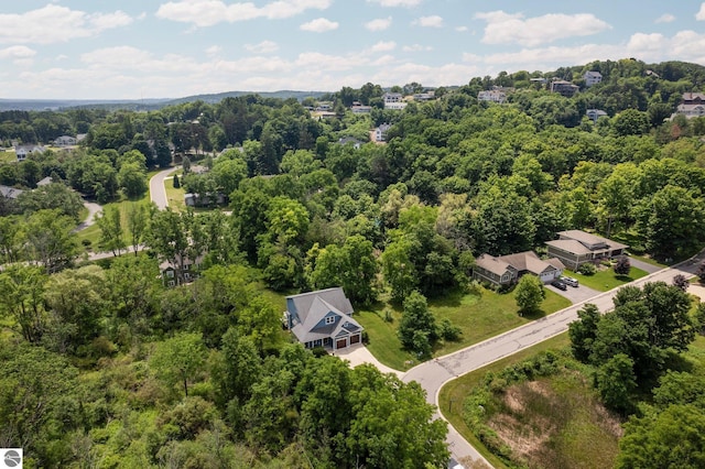 drone / aerial view featuring a forest view