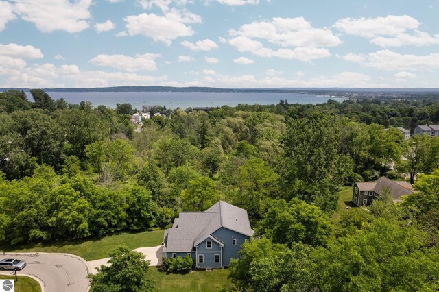 aerial view featuring a forest view and a water view