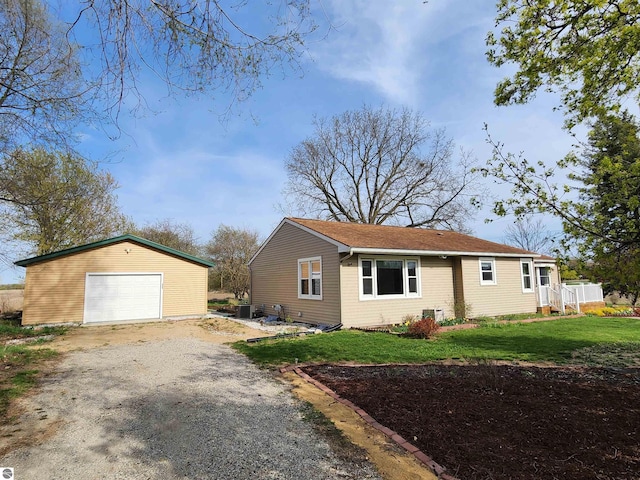 view of front of house featuring a front yard, dirt driveway, an outbuilding, a garage, and cooling unit