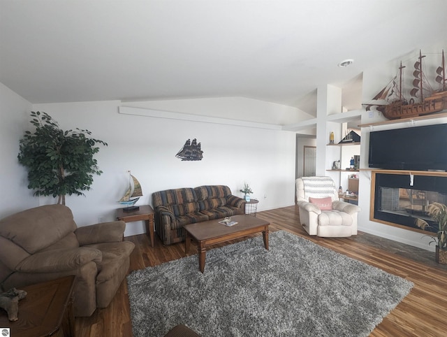 living area featuring vaulted ceiling and wood finished floors