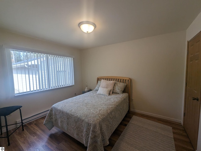 bedroom featuring baseboards and wood finished floors