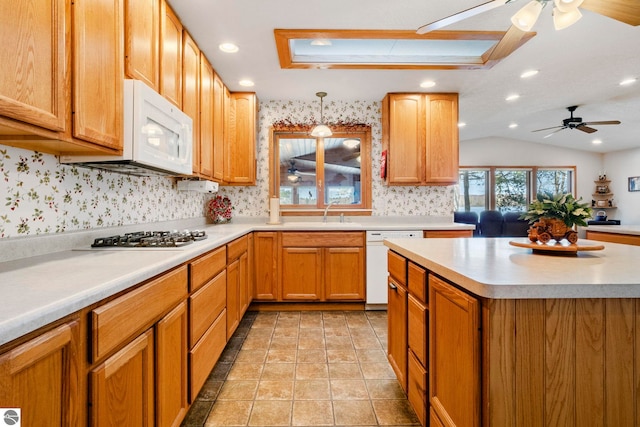 5449 E Shore Dr NE, Kalkaska, MI 49646 - kitchen with white appliances, ceiling fan, light countertops, backsplash, and a sink
