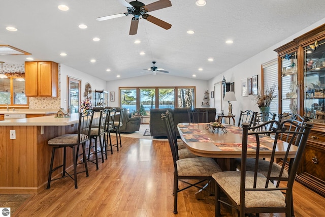 5449 E Shore Dr NE, Kalkaska, MI 49646 - dining space featuring a ceiling fan, light wood-style floors, lofted ceiling, recessed lighting, and a textured ceiling