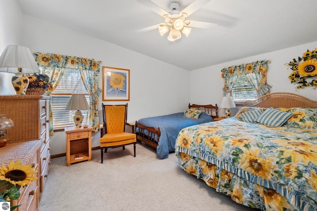5449 E Shore Dr NE, Kalkaska, MI 49646 - bedroom with light colored carpet, lofted ceiling, and a ceiling fan