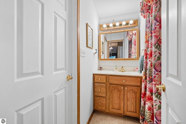5449 E Shore Dr NE, Kalkaska, MI 49646 - bathroom featuring vanity and baseboards