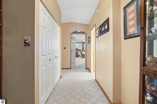 5449 E Shore Dr NE, Kalkaska, MI 49646 - hall featuring light colored carpet, baseboards, and vaulted ceiling