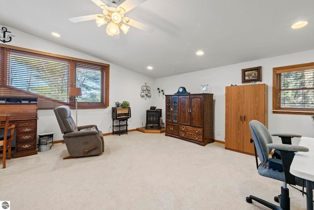 5449 E Shore Dr NE, Kalkaska, MI 49646 - carpeted office with a wood stove, vaulted ceiling, healthy amount of natural light, a ceiling fan, and recessed lighting