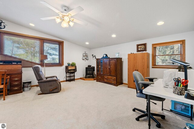 5449 E Shore Dr NE, Kalkaska, MI 49646 - office featuring vaulted ceiling, a wood stove, healthy amount of natural light, carpet flooring, and a ceiling fan