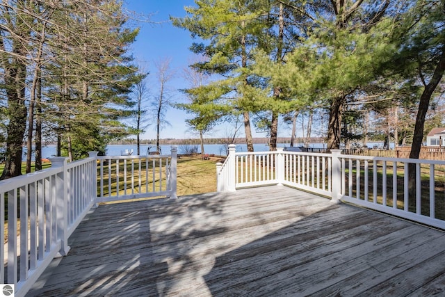 5449 E Shore Dr NE, Kalkaska, MI 49646 - deck featuring a water view and a fenced backyard