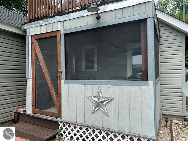 view of property exterior with a sunroom