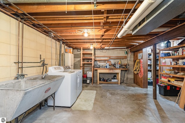 unfinished below grade area with a sink and washer and clothes dryer