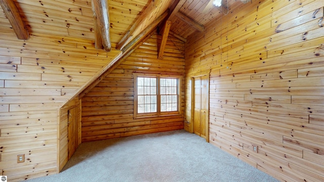 bonus room featuring lofted ceiling with beams, wood ceiling, and carpet