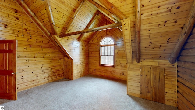 bonus room featuring lofted ceiling with beams, wooden walls, wooden ceiling, and carpet flooring