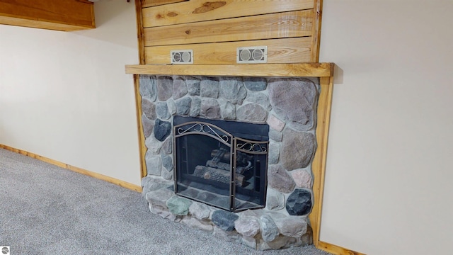 details featuring baseboards, a fireplace, and carpet flooring