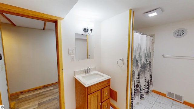 bathroom featuring a shower with curtain, visible vents, vanity, baseboards, and marble finish floor