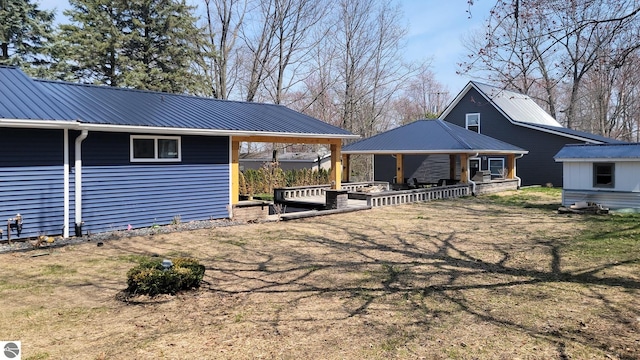 back of property featuring metal roof