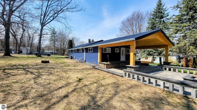 back of property with a chimney and metal roof