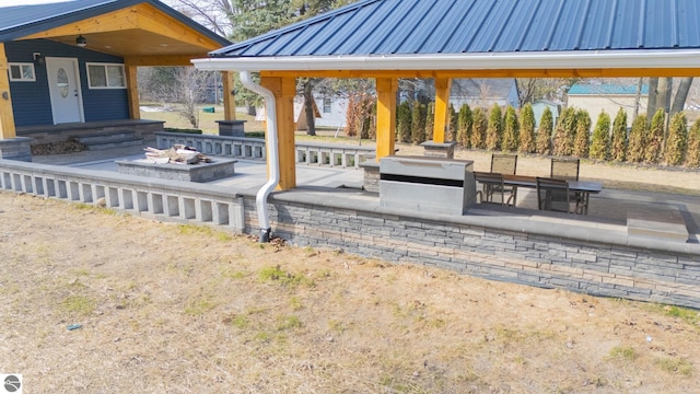 exterior space featuring an outdoor fire pit