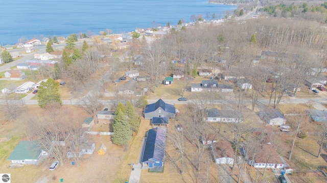 drone / aerial view with a residential view and a water view