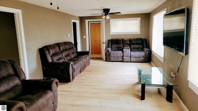 living room with light wood-style floors and ceiling fan