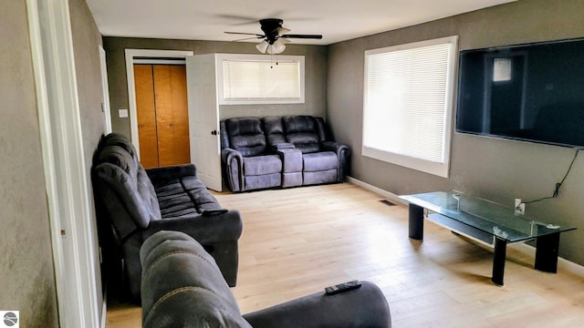 living area featuring a ceiling fan, visible vents, and light wood-type flooring