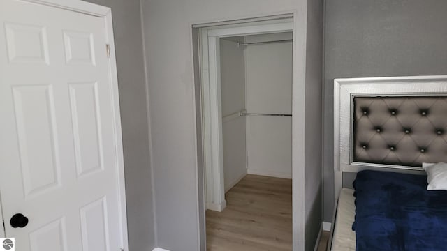 bathroom with baseboards and wood finished floors