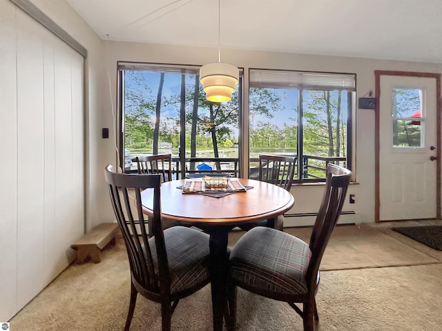 dining room with light colored carpet and baseboard heating