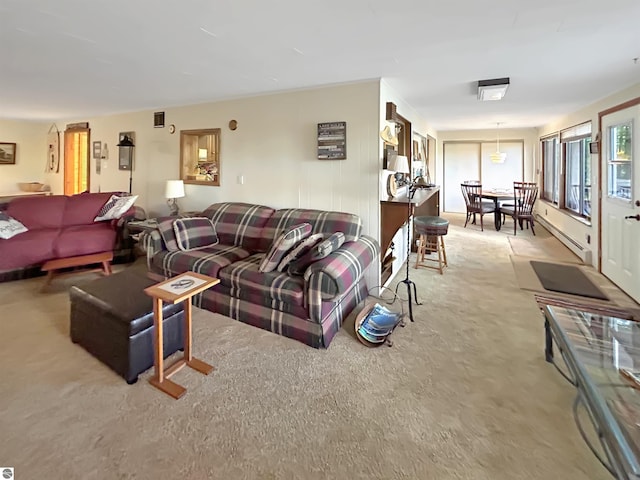 living area featuring a baseboard heating unit and light carpet