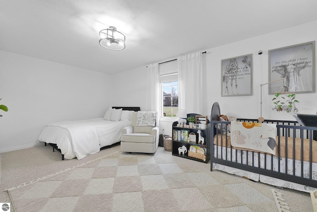 carpeted bedroom with baseboards