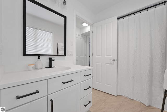 bathroom with vanity and marble finish floor