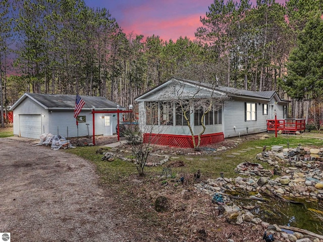 9916 S M-37, Buckley, MI 49620 - manufactured / mobile home with a sunroom, a wooden deck, an outbuilding, and a detached garage