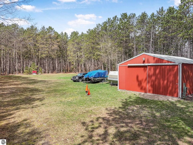 9916 S M-37, Buckley, MI 49620 - view of yard featuring a pole building, a view of trees, and an outbuilding