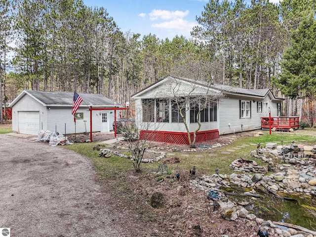 9916 S M-37, Buckley, MI 49620 - manufactured / mobile home with a sunroom, an outbuilding, a deck, and a detached garage